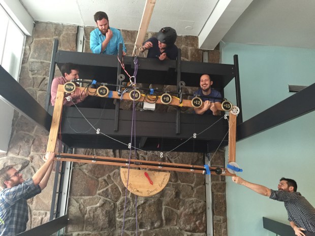The team at interactive agency Viget in Boulder hoist up the Temperometer onto what used to be DJ booth. 