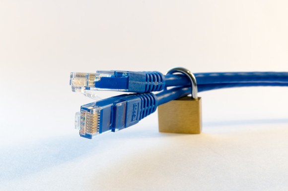 Secure data transfer concept, using a padlock around Ethernet cables.